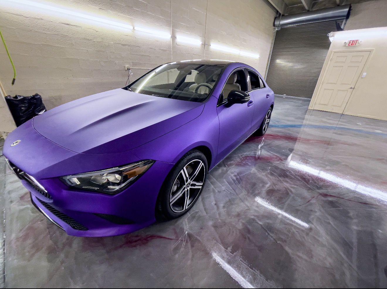 Metallic epoxy showroom floor with a purple vehicle in Cuyahoga Falls, Ohio